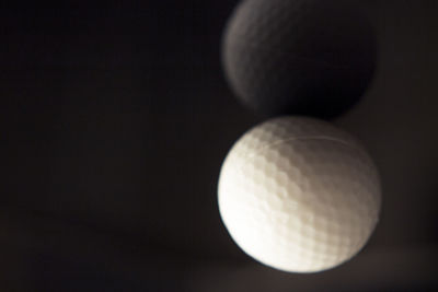 Close-up of ball on table against black background