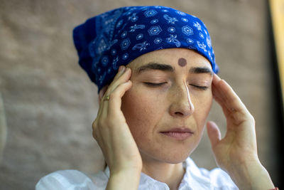 Close-up of woman meditating at home