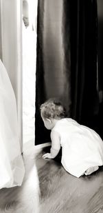 Midsection of woman lying down on bed at home