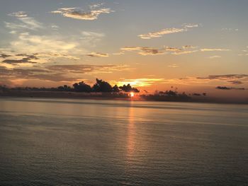 Scenic view of sea against romantic sky at sunset