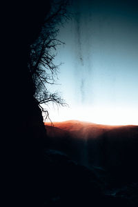 Waterfall fall over the cliff with clear sky on sunset