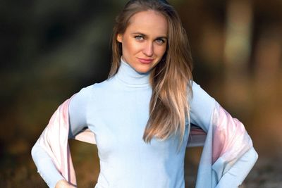 Portrait of smiling young woman standing outdoors