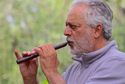 Midsection of man smoking cigarette