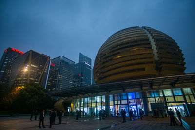 Low angle view of illuminated modern buildings in city