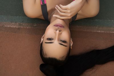 Portrait of woman lying down on floor