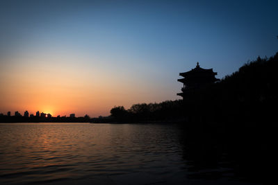 Silhouette of building at sunset