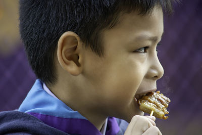 Close-up of boy eating food