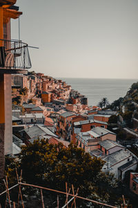 High angle view of buildings and sea against clear sky