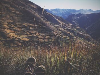 Low section of man standing on mountain