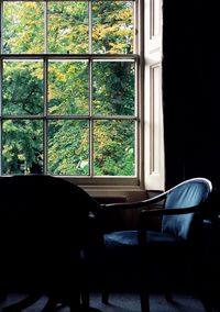 Empty chair seen through glass window