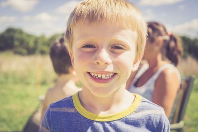 Portrait of smiling boy on field