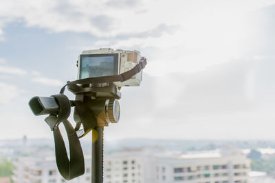 Close-up of coin-operated binoculars against sky