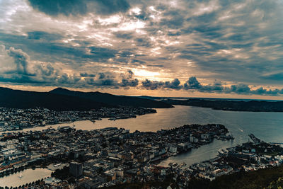 High angle view of city by sea against sky