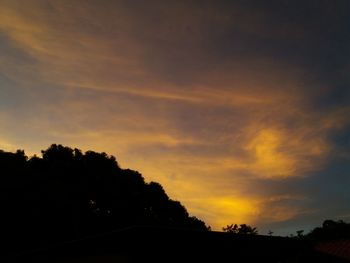 Low angle view of silhouette trees against sky during sunset