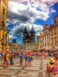 Tourists against cloudy sky