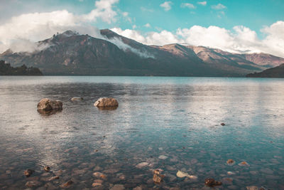 Scenic view of lake and mountains against sky