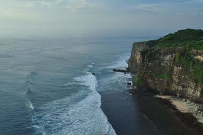 Scenic view of sea by cliff