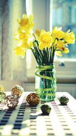 Close-up of yellow tulips in vase on table