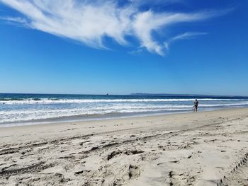 Scenic view of beach against blue sky