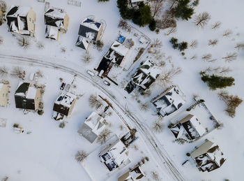 High angle view of snow covered field by building