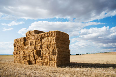 Country landscape with a dry haystack with blue sky and some clouds