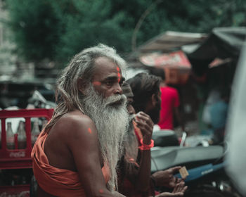 Portrait of shirtless man using mobile phone