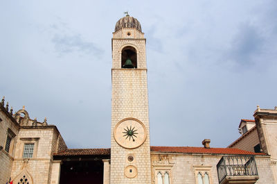 Low angle view of bell tower against sky