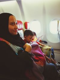 Woman with children sitting in airplane