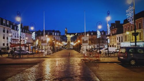 Illuminated city street at night