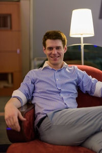 Portrait of smiling man sitting at home