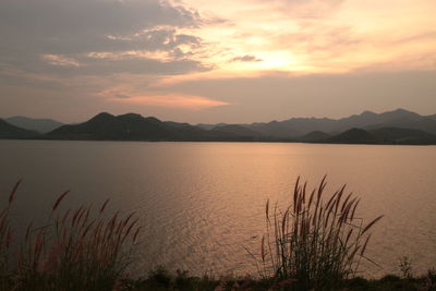 Scenic view of lake against sky during sunset