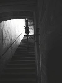 Low angle view of silhouette man on staircase in building