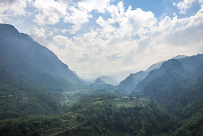 Scenic view of mountains against cloudy sky