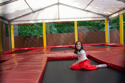 Happy lsports girl having fun while jumping on trampoline