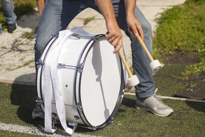 Drum on football. football fan beats drumsticks into membrane. 