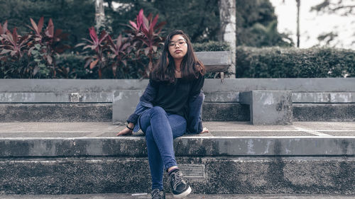 Portrait of a young woman sitting outdoors