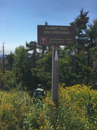 Information sign against blue sky