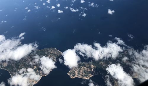 Low angle view of rocks in sea against sky