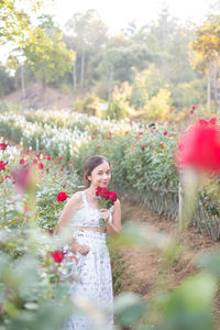 Rear view of woman holding flowers