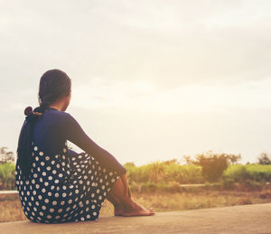 Rear view of woman looking at sunset