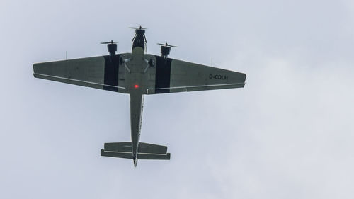 Low angle view of windmill against sky