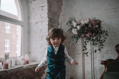 Portrait of smiling boy standing at home