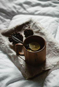 High angle view of tea cup on bed