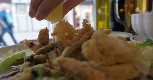 Close-up of hand holding meat