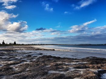 View of beach against cloudy sky