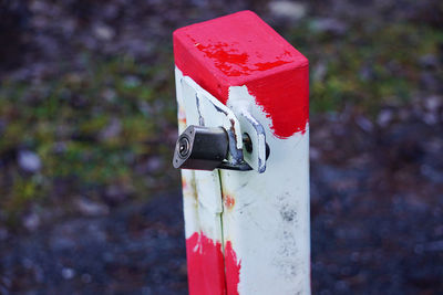 Close-up of red mailbox on field