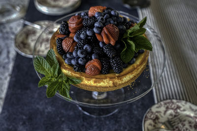 Cheesecake and berries with mint leaves