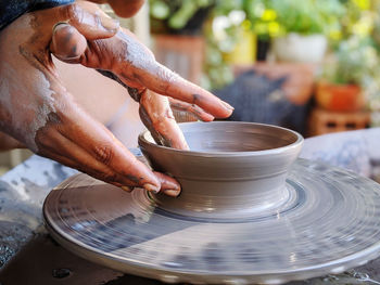 Woman making clay pot ok pottery wheel