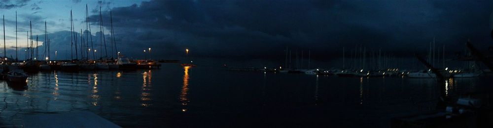 View of illuminated harbor at night