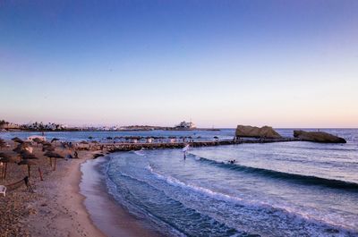 Scenic view of sea against clear sky during sunset